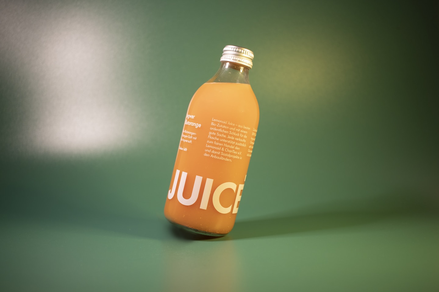 Product Shot of a slanted bottle with yellow and green color tones